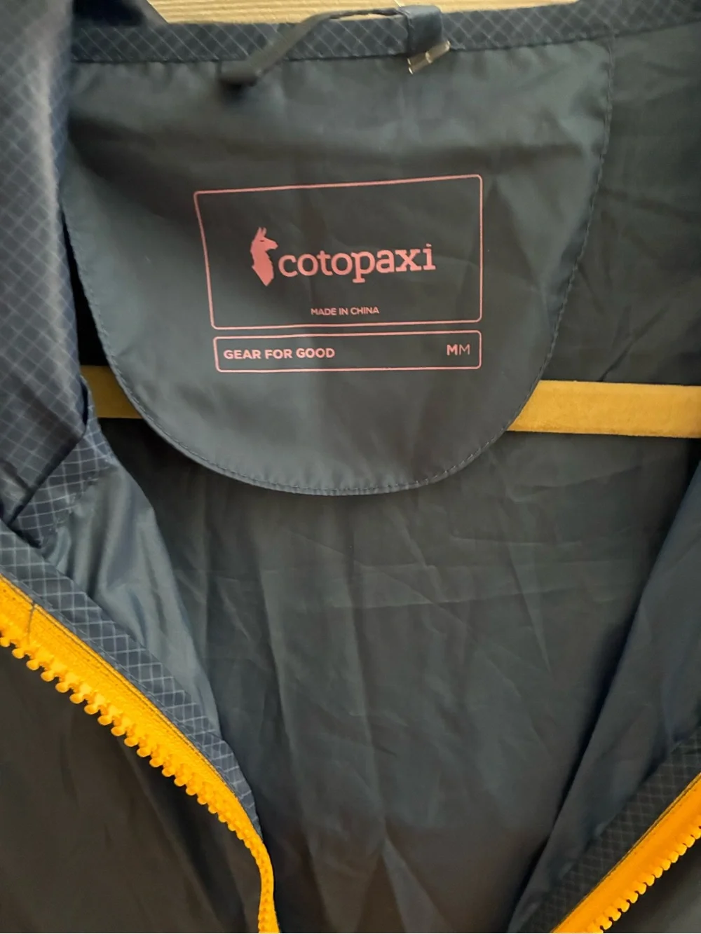 cotopaxi Navy Jacket with Yellow Zipper and Pink Logo